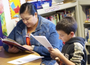 Volunteer reading with student
