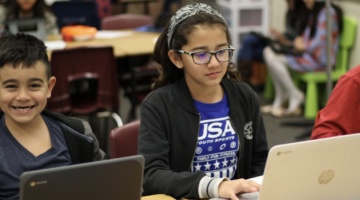 male and female students on computers