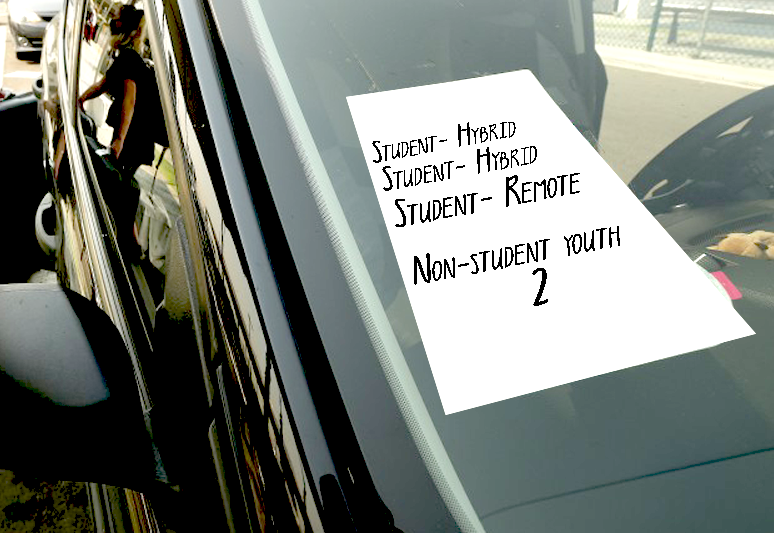 Car windshield with note saying Student- Hybrid Student- Hybrid Student- Remote Non-student youth 2