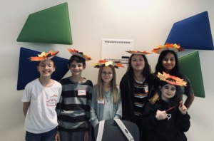 Five students showing off their Thanksgiving hats they made of construction paper