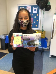 Girl with wearing a cheetah mask holding a virtual reality headset and iq card set