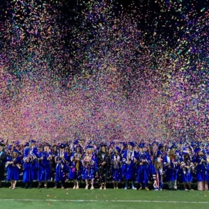 SDPA students graduating at SHS. Picture shows students celebrating their graduation. Confetti thrown in the air.