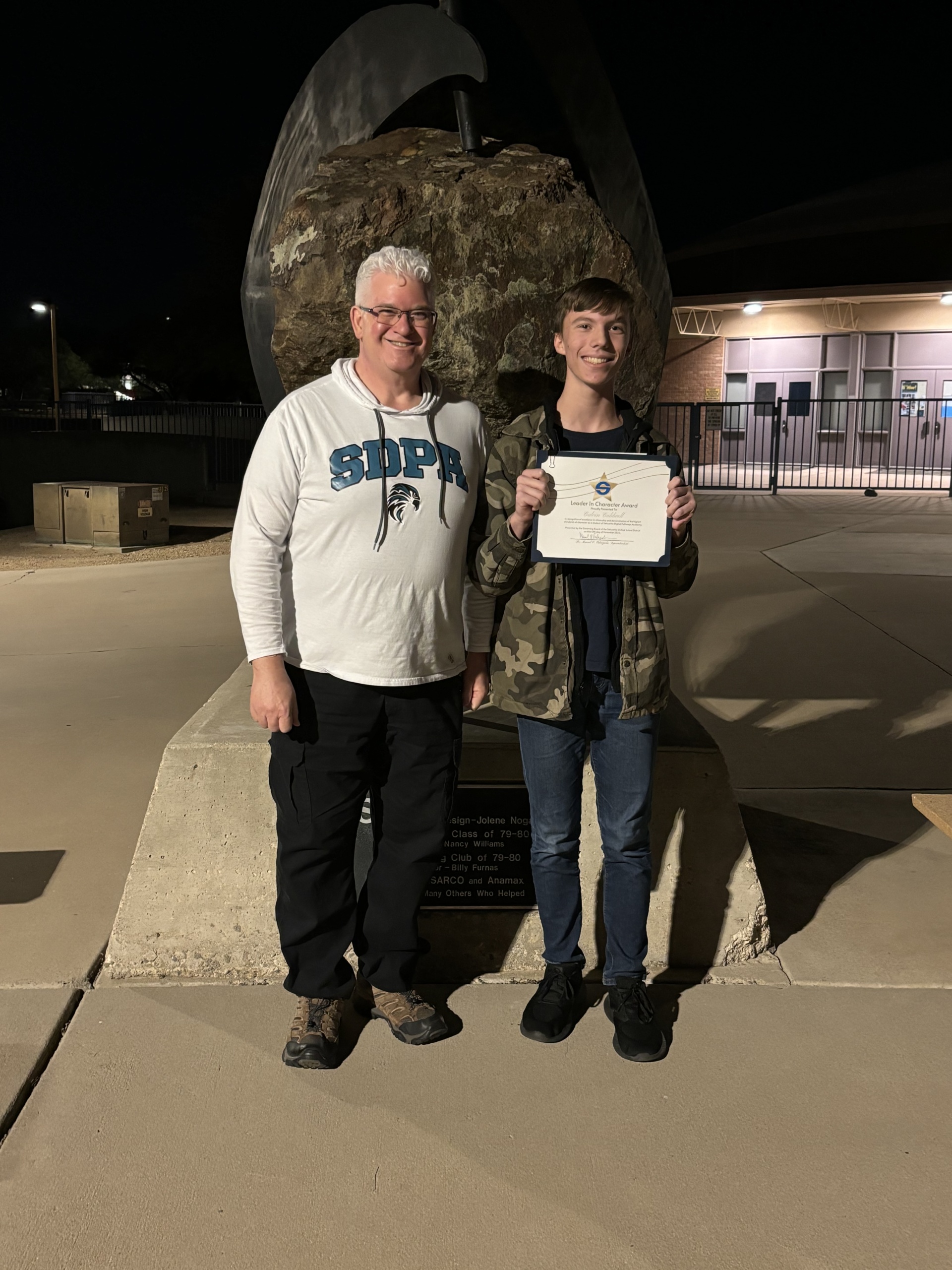 SDPA Teacher, Mr. Eves giving a certificate to one of his SDPA student.