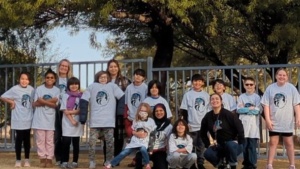 Image of SDPA Elementary students. Standing in front of a tree.